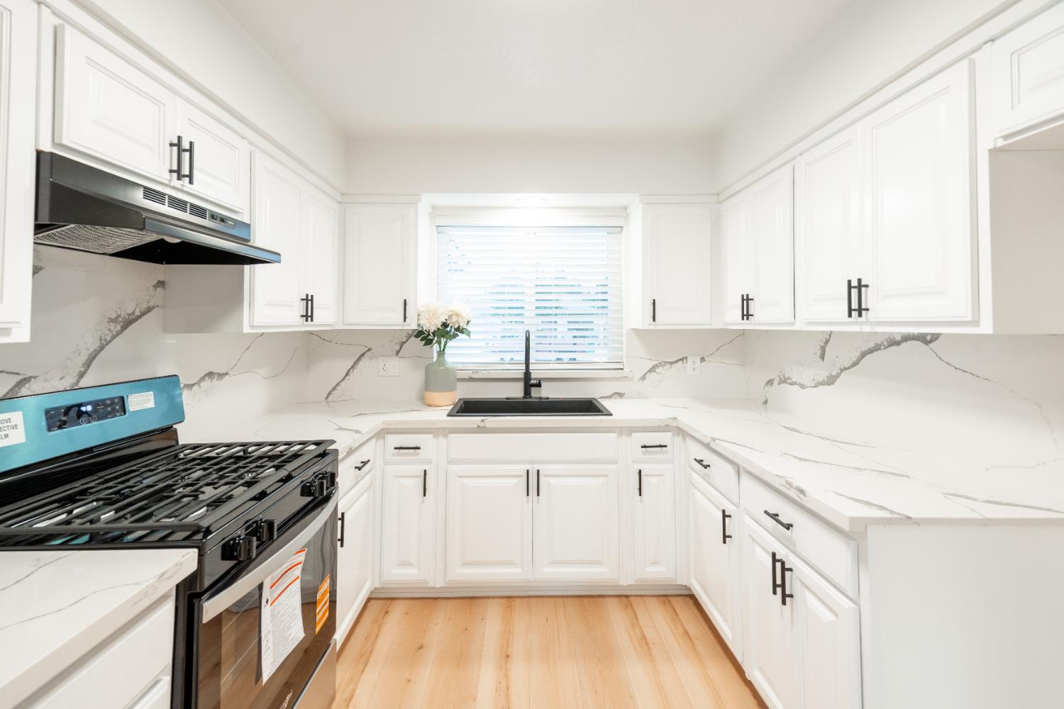 2612 Renn Avenue Clovis, CA 93611 - Photo 7 of 36 a white kitchen with sink and cabinets