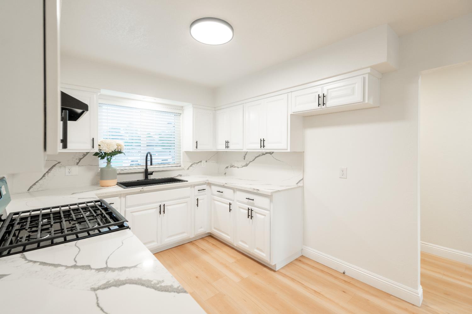 2612 Renn Avenue Clovis, CA 93611 - Photo 8 of 36 a kitchen with a sink a stove and white cabinets