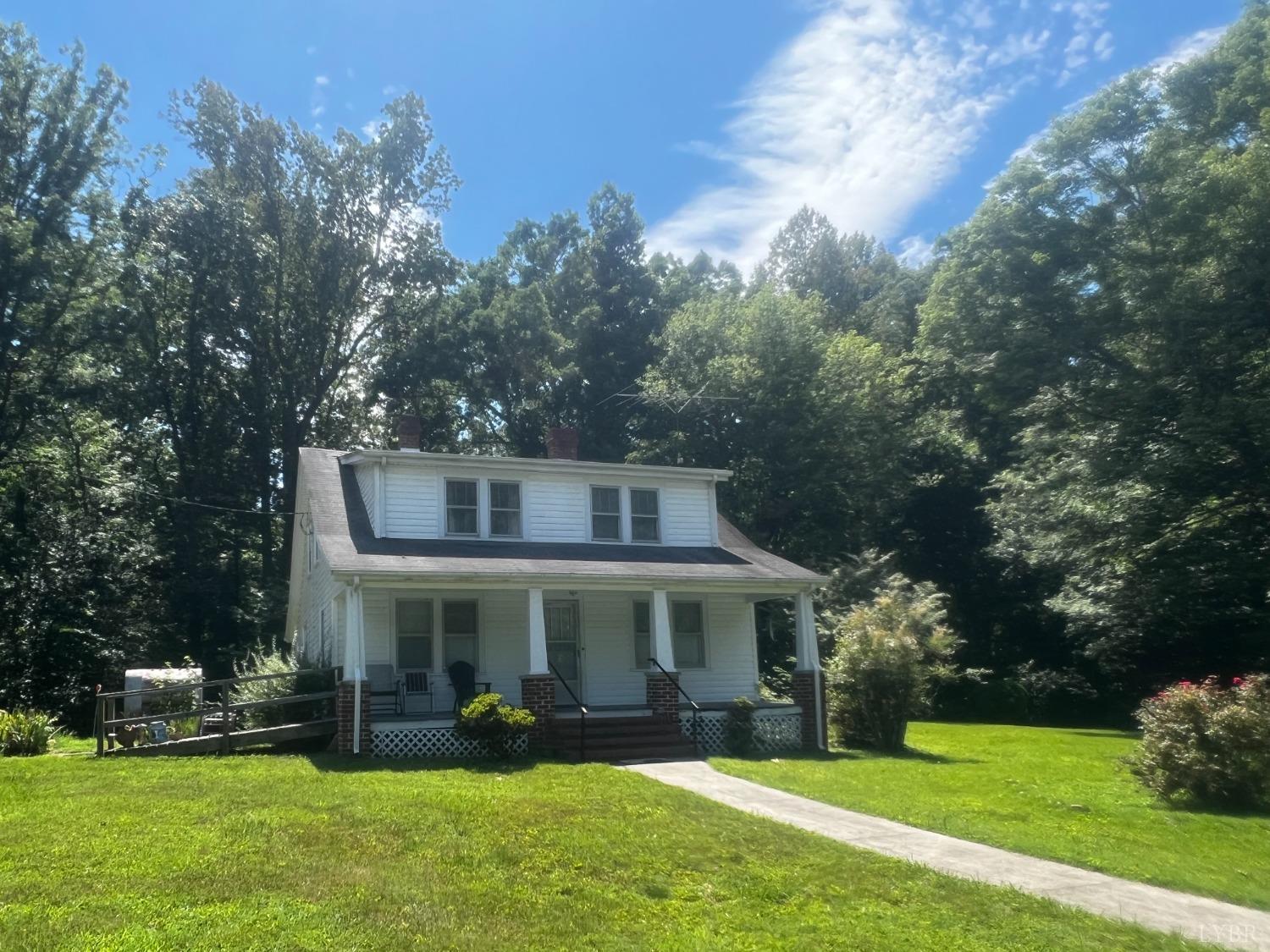 1131 Cody Road Nathalie, VA 24577 - Photo 1 of 28 a front view of a house with a garden