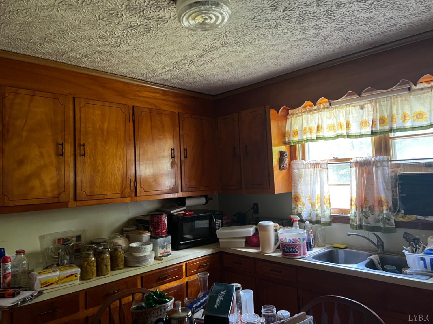 1131 Cody Road Nathalie, VA 24577 - Photo 8 of 28 a kitchen with a sink cabinets and window