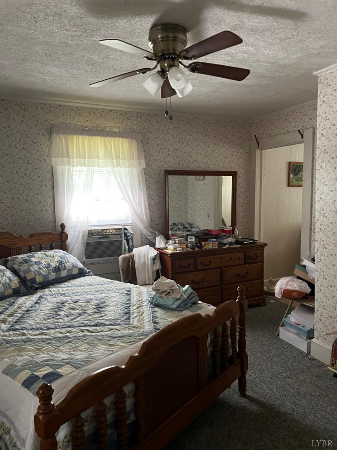 1131 Cody Road Nathalie, VA 24577 - Photo 10 of 28 a bedroom with a bed and a chandelier