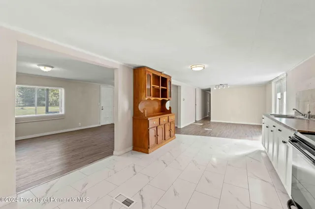a view of a kitchen with a sink and cabinets
