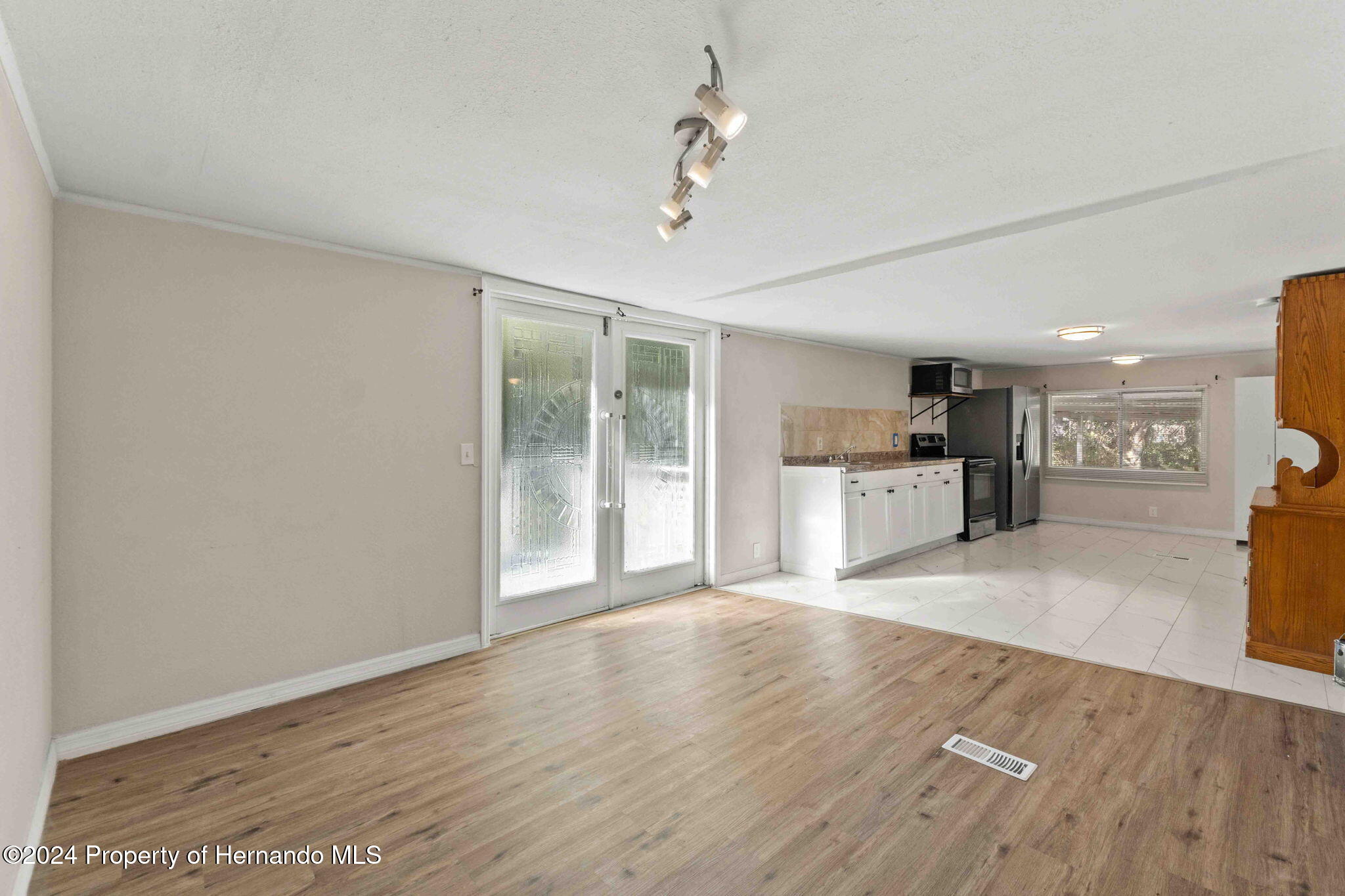 4265 North Beginning Path Crystal River, FL 34428 - Photo 15 of 30 a view of a kitchen with wooden floor and a kitchen space