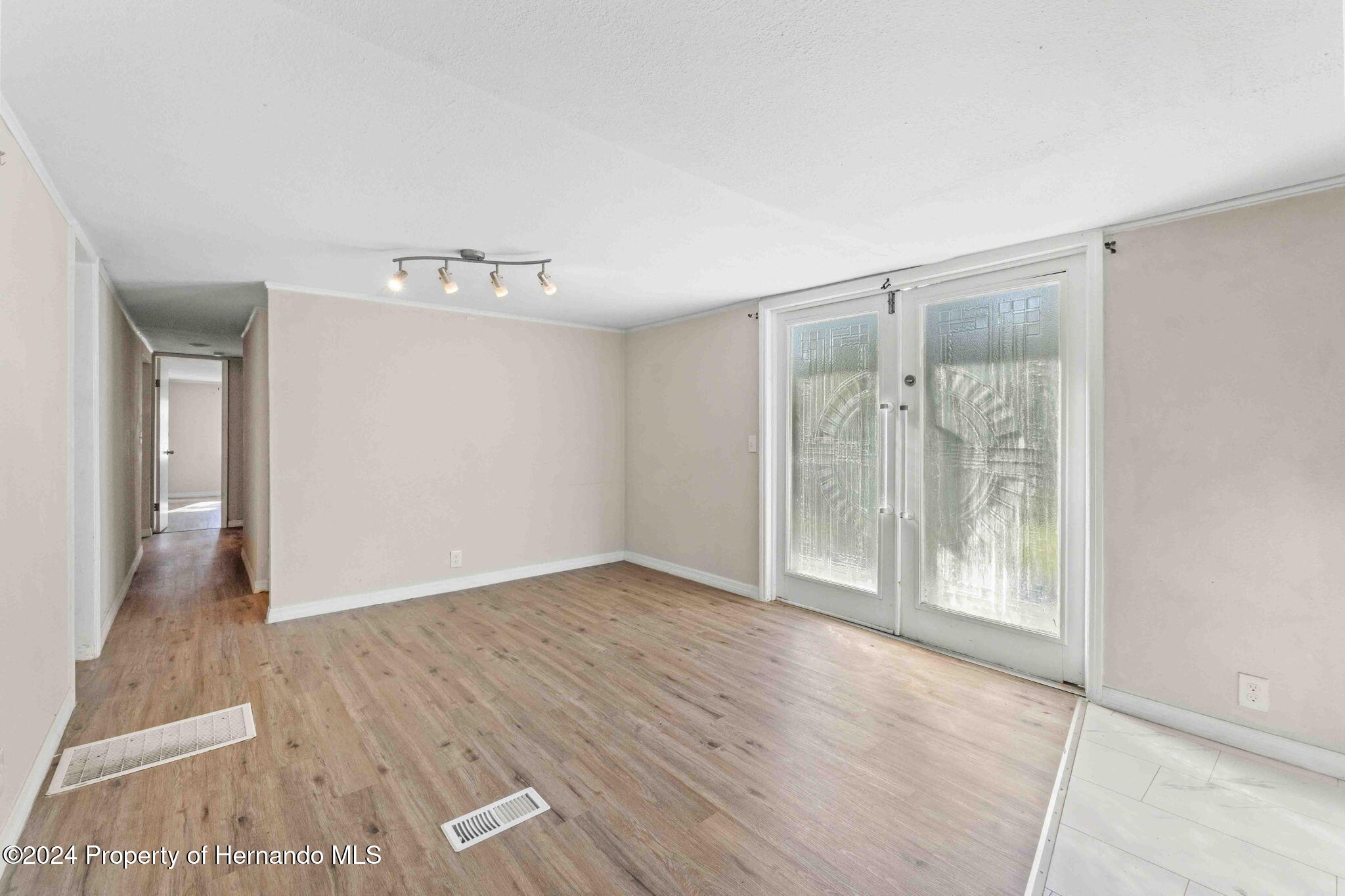 4265 North Beginning Path Crystal River, FL 34428 - Photo 17 of 30 a view of an empty room with wooden floor and a window