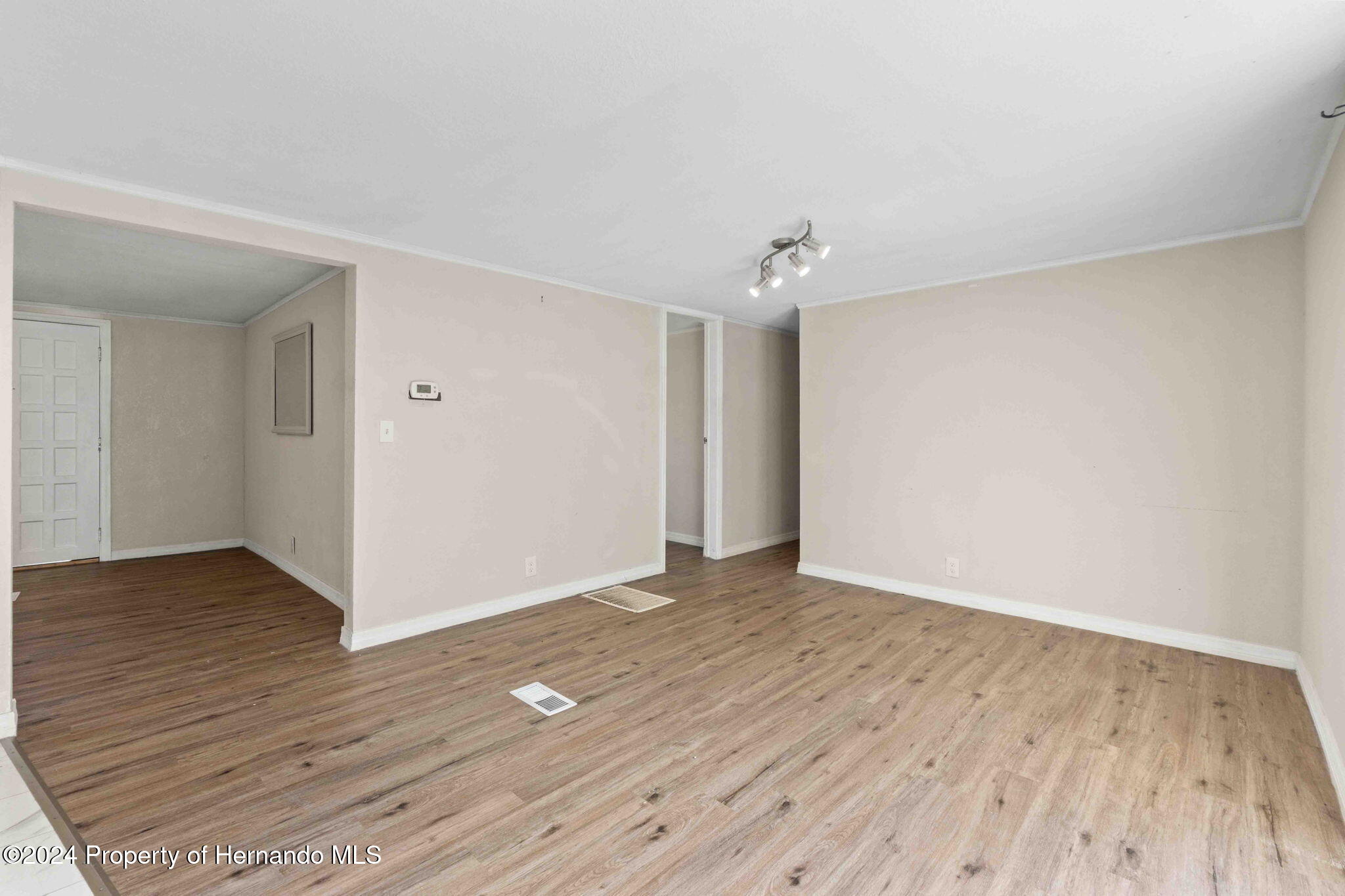 4265 North Beginning Path Crystal River, FL 34428 - Photo 18 of 30 a view of an empty room with wooden floor