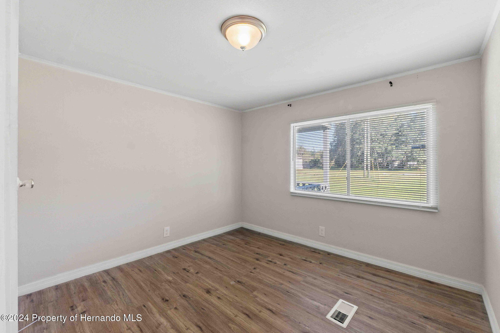 4265 North Beginning Path Crystal River, FL 34428 - Photo 20 of 30 an empty room with wooden floor and windows