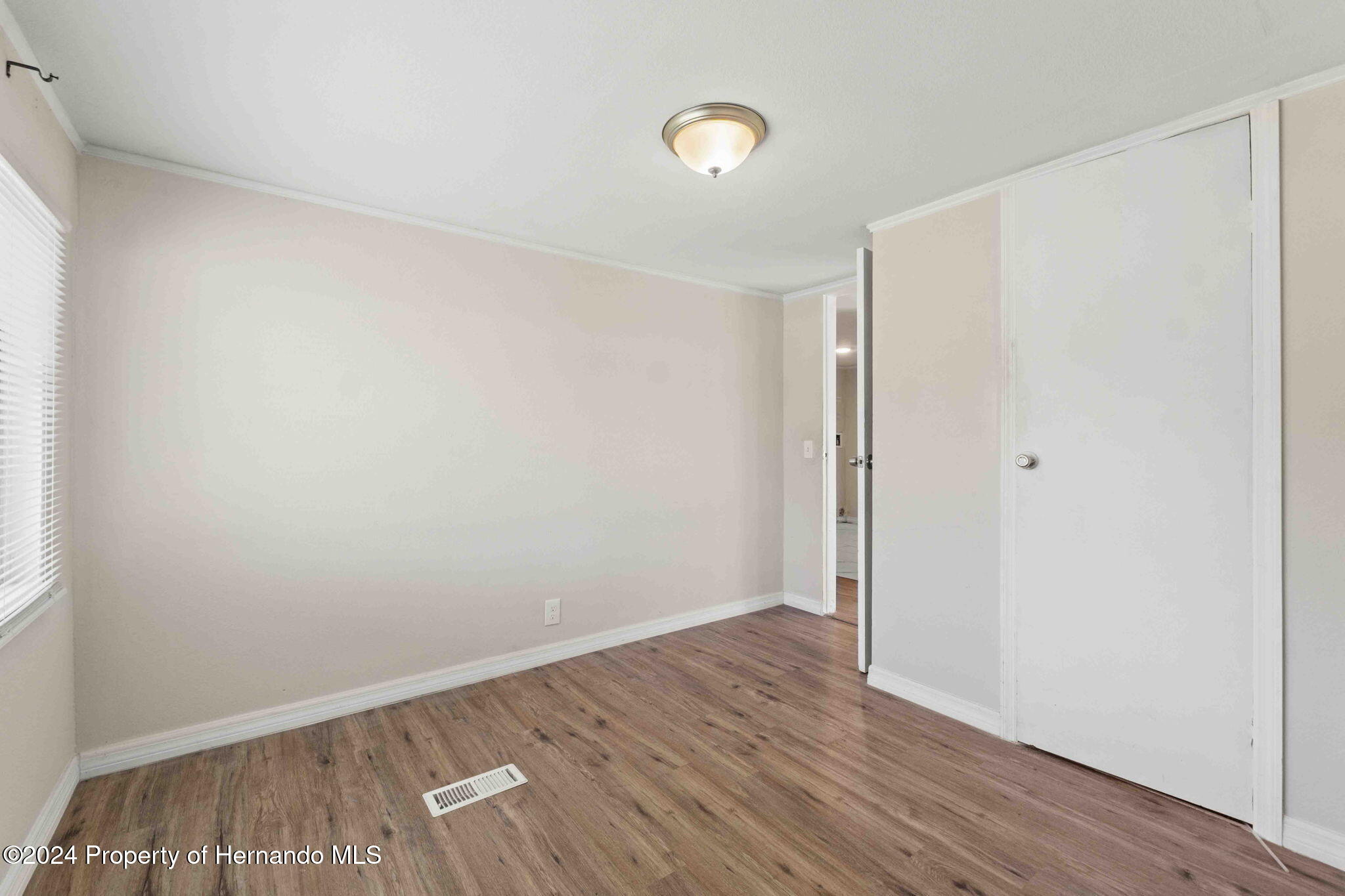 4265 North Beginning Path Crystal River, FL 34428 - Photo 21 of 30 an empty room with wooden floor and windows