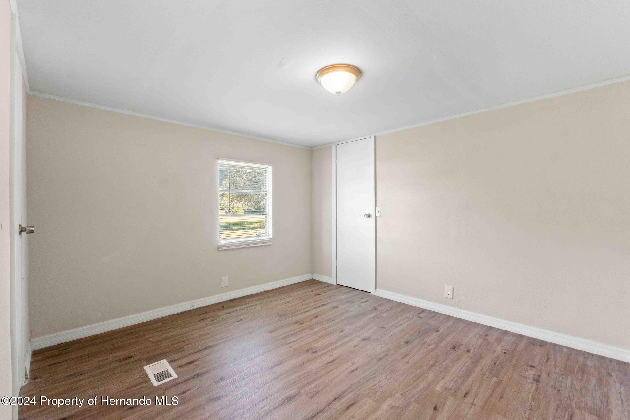 4265 North Beginning Path Crystal River, FL 34428 - Photo 25 of 30 an empty room with wooden floor and windows