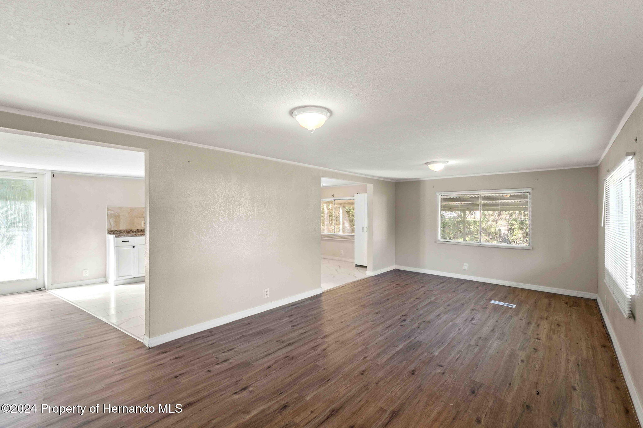 4265 North Beginning Path Crystal River, FL 34428 - Photo 4 of 30 an empty room with wooden floor and windows