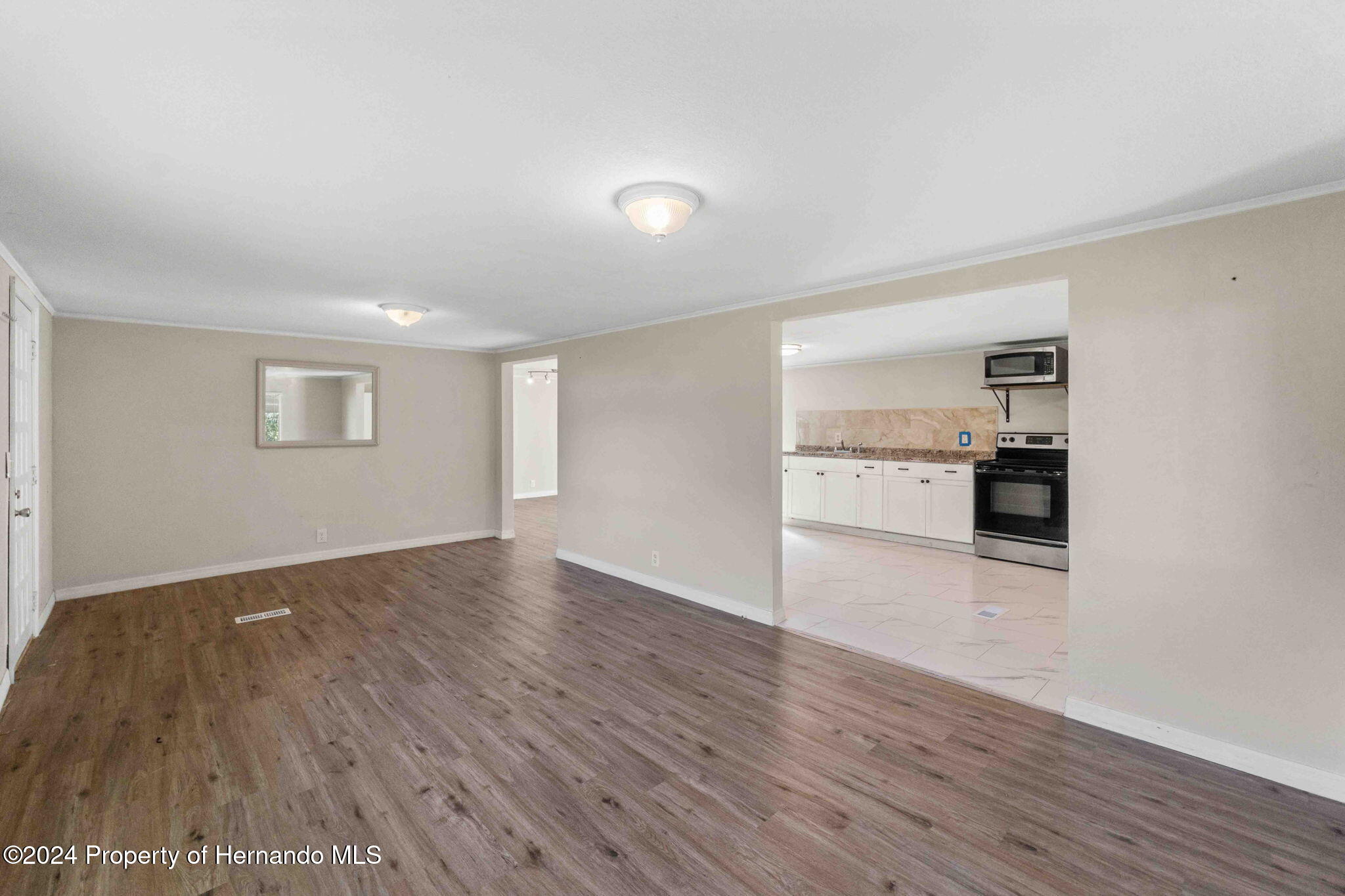 4265 North Beginning Path Crystal River, FL 34428 - Photo 5 of 30 a view of a kitchen with wooden floor and a kitchen