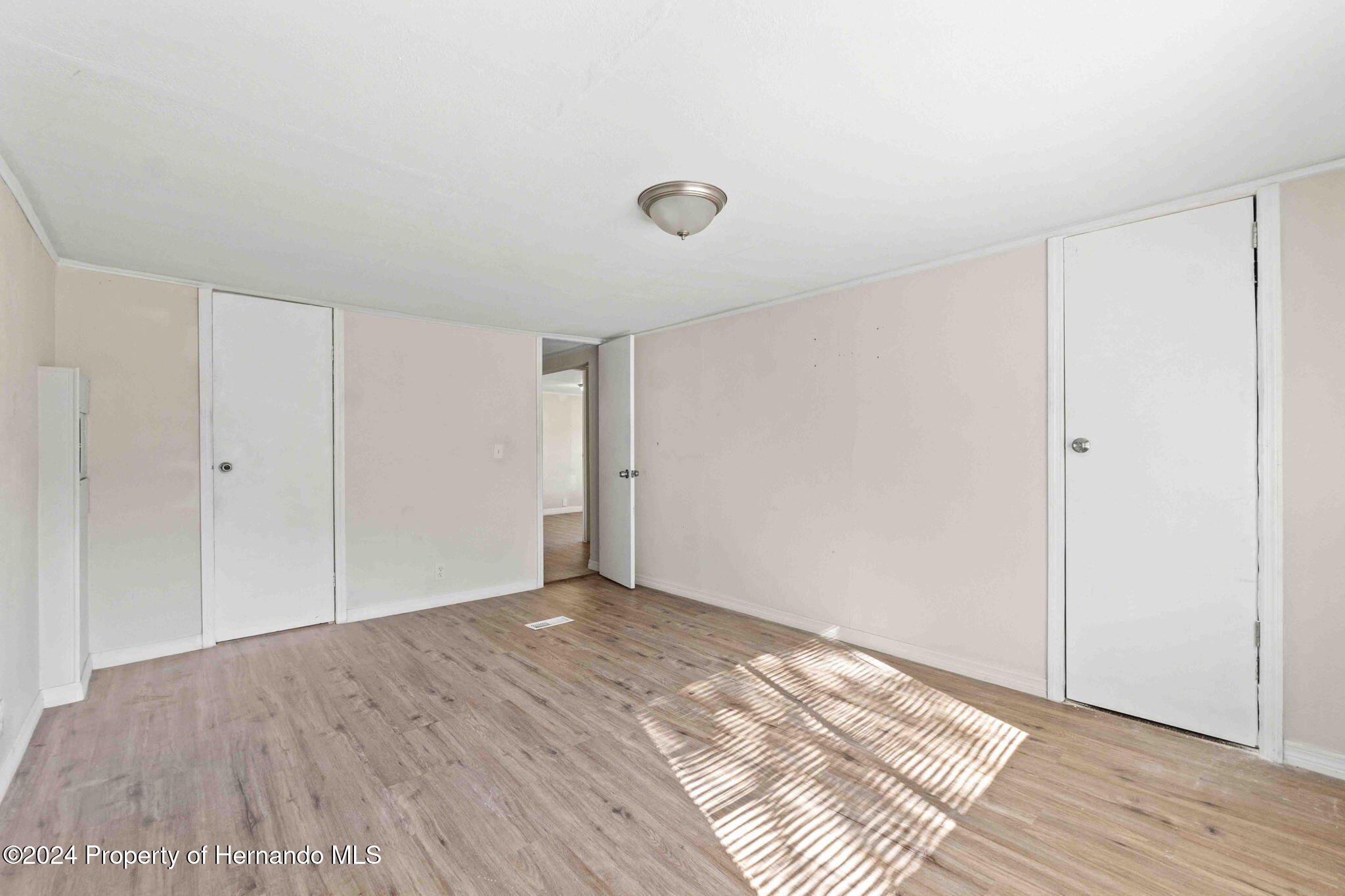 4265 North Beginning Path Crystal River, FL 34428 - Photo 9 of 30 a view of an empty room with wooden floor