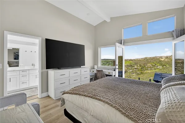 a bedroom with a bed and a flat screen tv