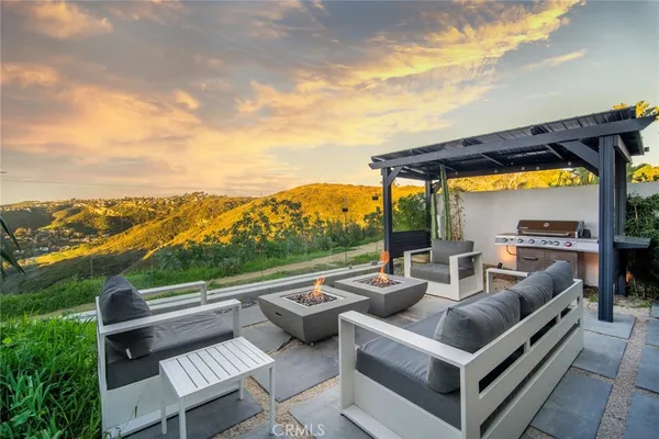 a view of balcony with couches and wooden floor
