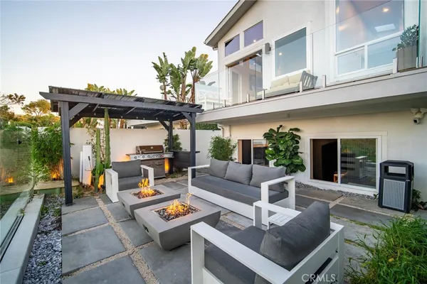 a view of a patio with couches table and chairs with potted plants