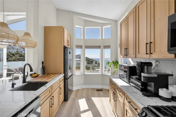 a kitchen with a sink stove and cabinets