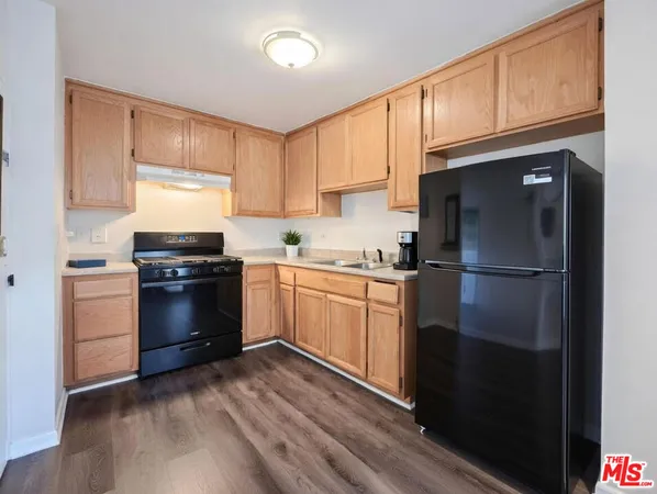 a kitchen with a refrigerator stove and white cabinets