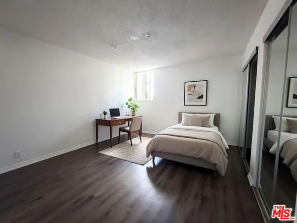 a bedroom with a bed and a table in it