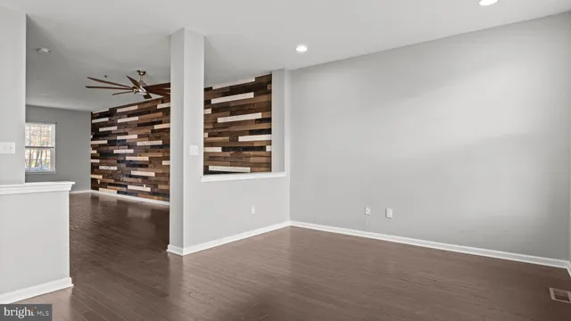 a view of wooden floor and windows in a room