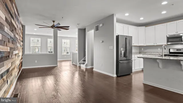 a kitchen with stainless steel appliances a refrigerator and a stove top oven