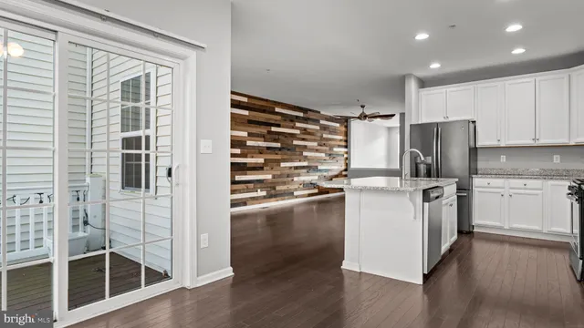 a kitchen with refrigerator cabinets and wooden floor