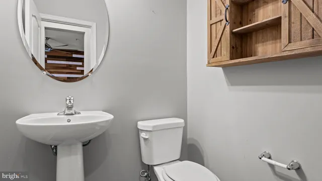a bathroom with a sink a mirror and a toilet
