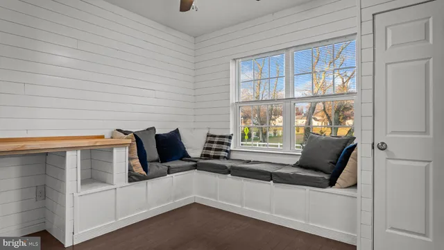 a living room with furniture and large windows