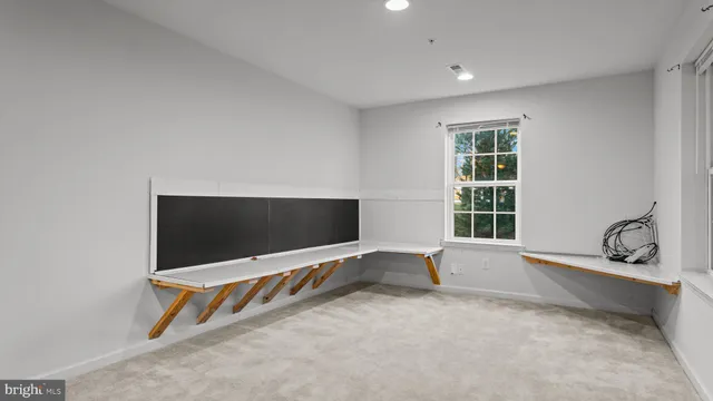 a view of an empty room with a flat screen tv and a window