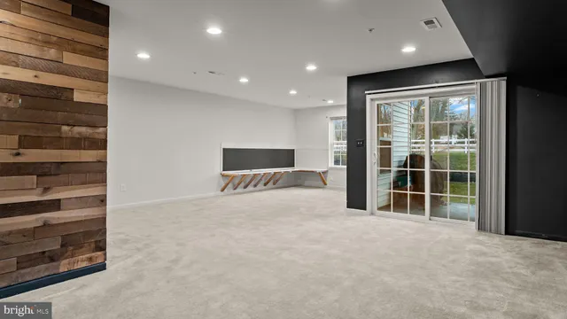 a view of an empty room with a balcony and a fireplace