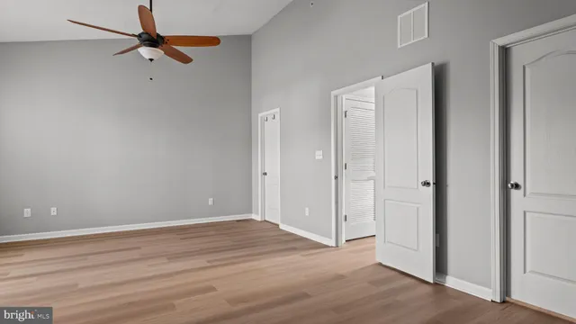 a view of an empty room with wooden floor