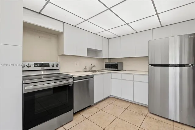 a kitchen with cabinets appliances and a counter top