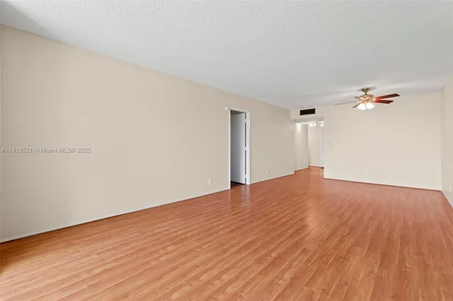 a view of an empty room and wooden floor