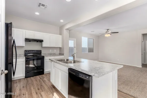 a kitchen with a stove and a sink