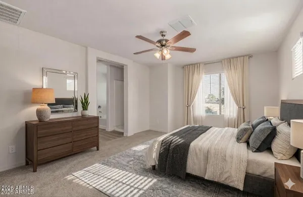 a bedroom with a bed and window