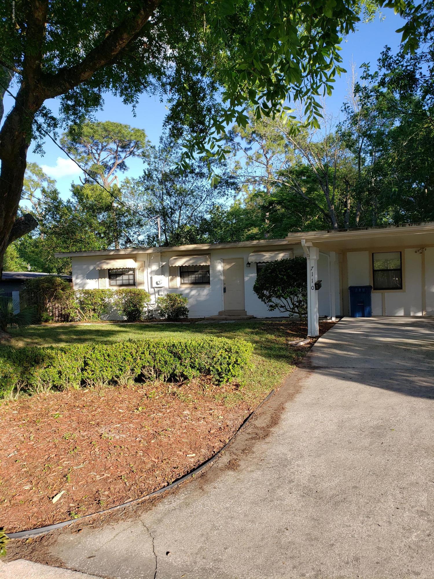 7110 Oakney Road Jacksonville, FL 32211 - Photo 1 of 15 front view of a house with a yard