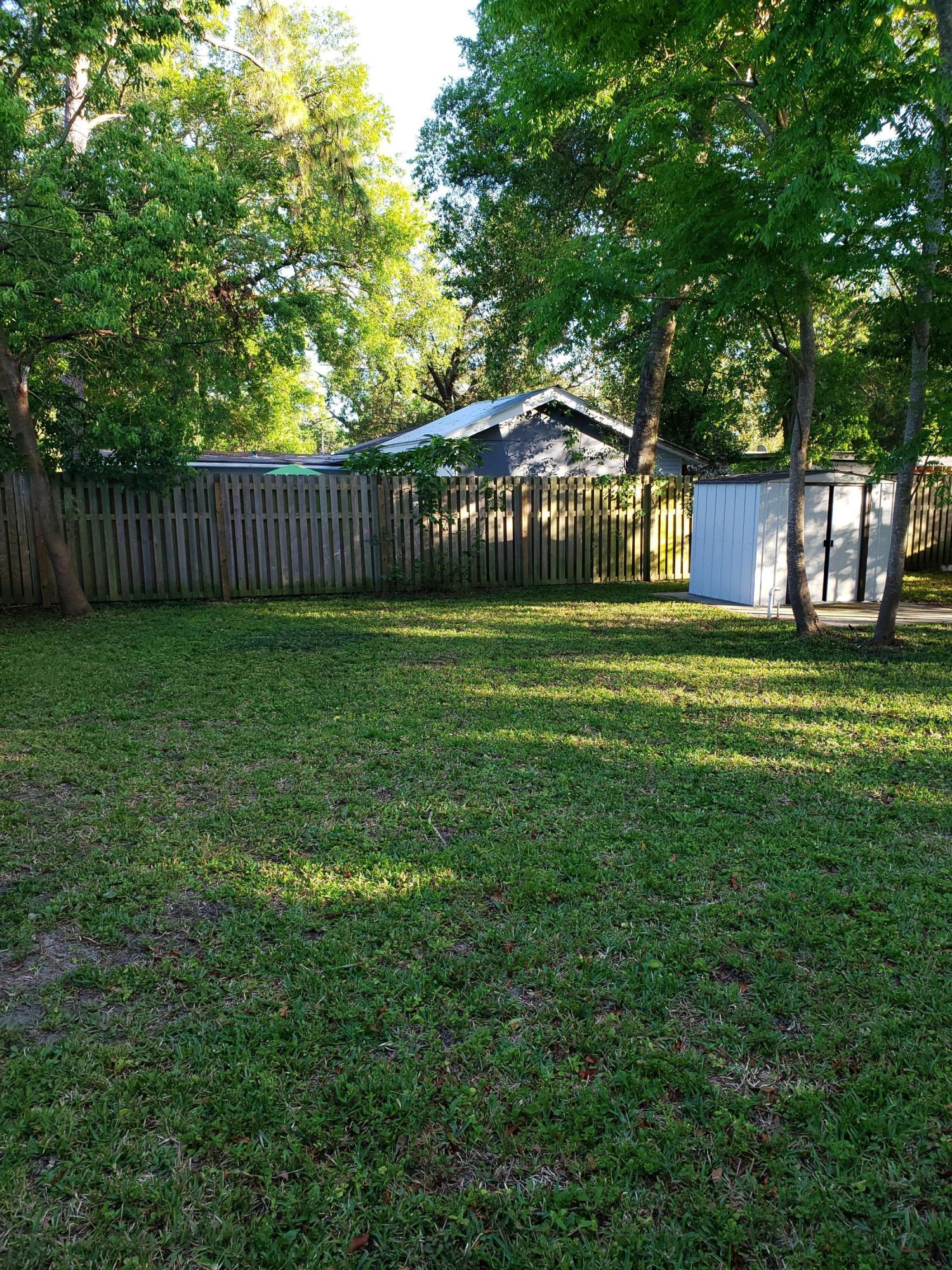 7110 Oakney Road Jacksonville, FL 32211 - Photo 13 of 15 a view of a big yard next to a house