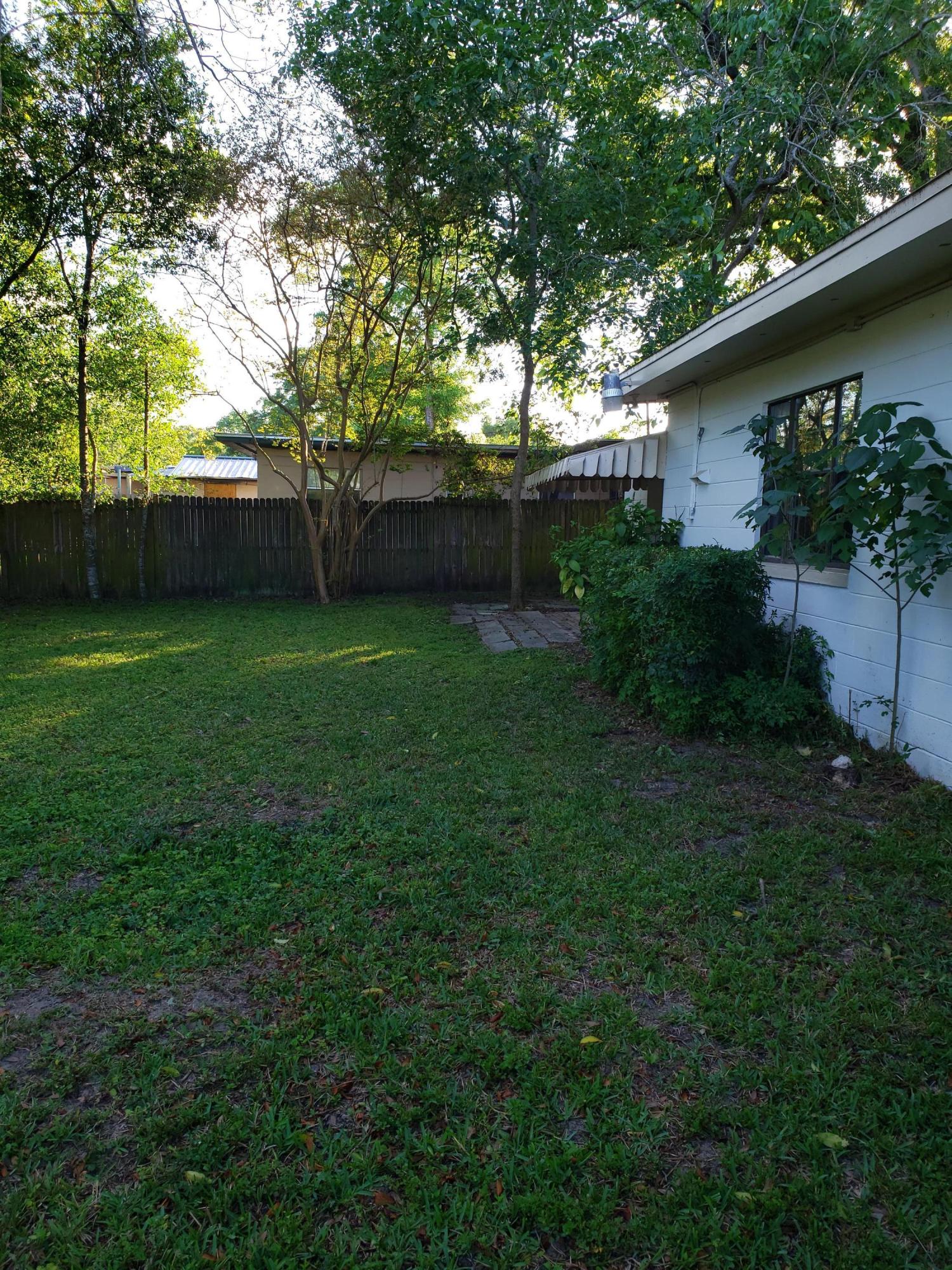 7110 Oakney Road Jacksonville, FL 32211 - Photo 14 of 15 a view of a backyard with plants and a large tree