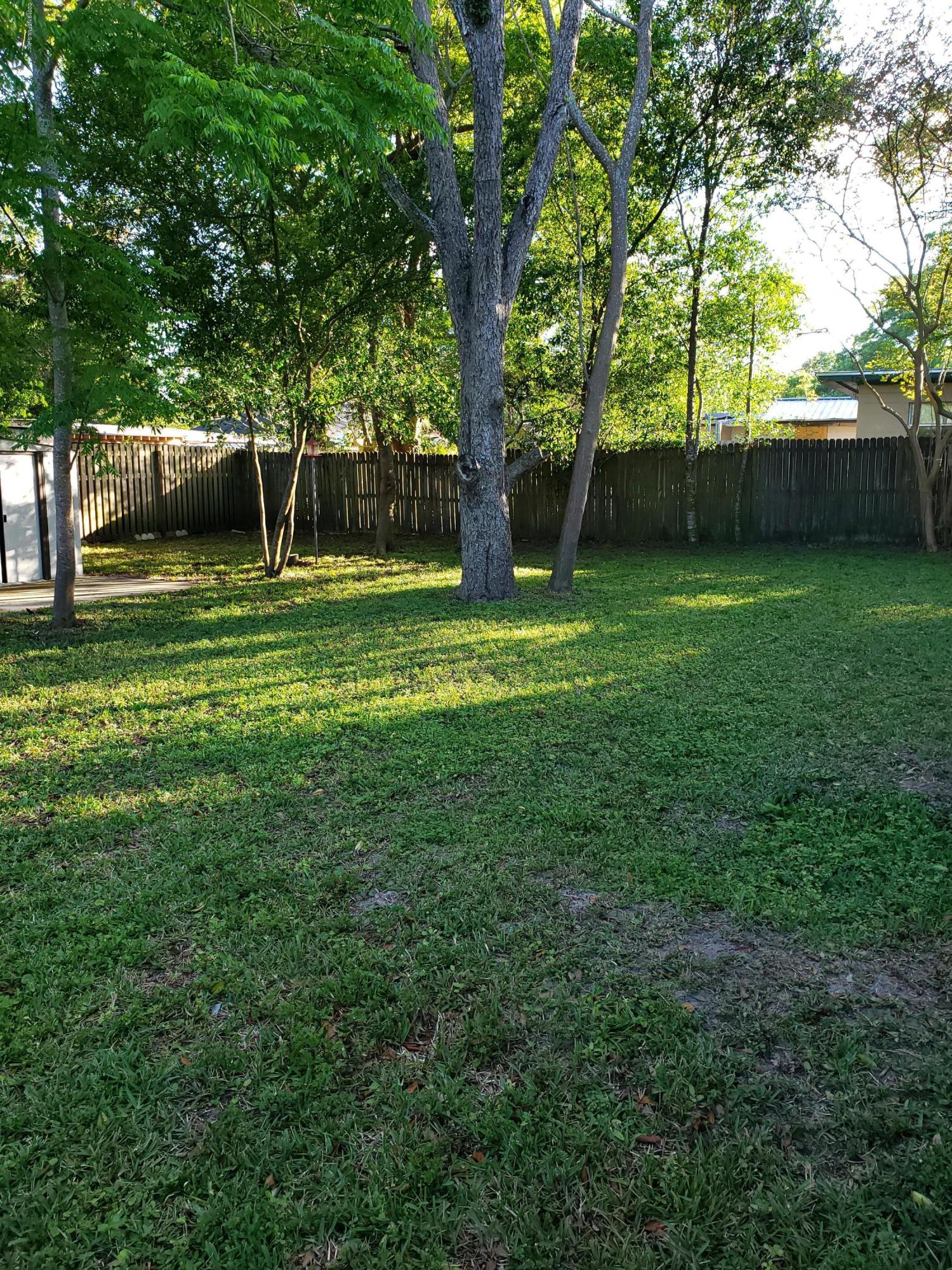 7110 Oakney Road Jacksonville, FL 32211 - Photo 15 of 15 a view of a backyard with a garden and trees