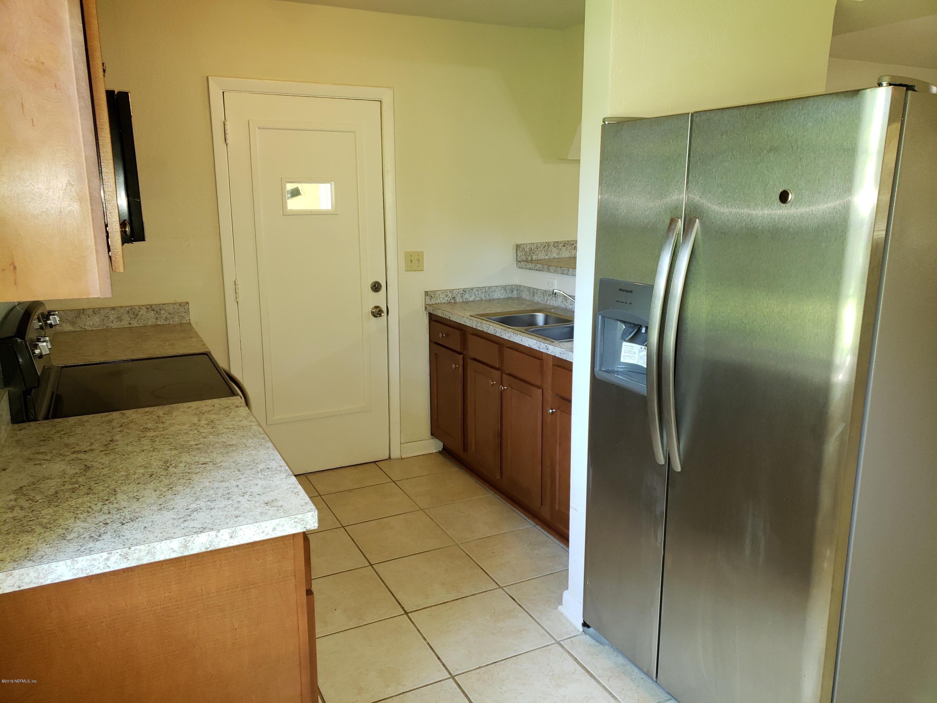 7110 Oakney Road Jacksonville, FL 32211 - Photo 5 of 15 a kitchen with stainless steel appliances granite countertop a sink and a refrigerator