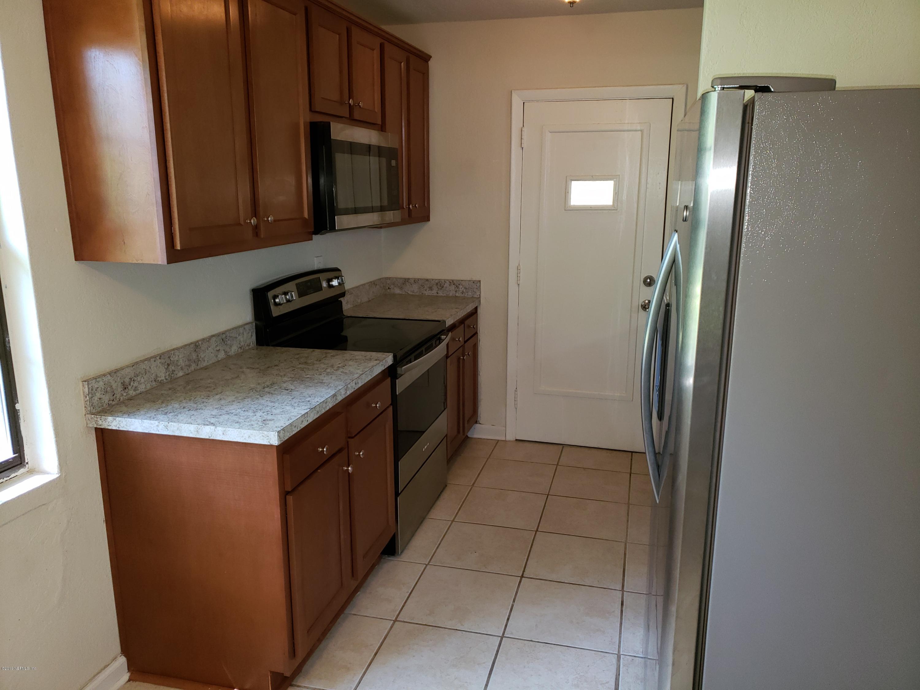 7110 Oakney Road Jacksonville, FL 32211 - Photo 6 of 15 a kitchen with stainless steel appliances granite countertop a stove a refrigerator and a microwave