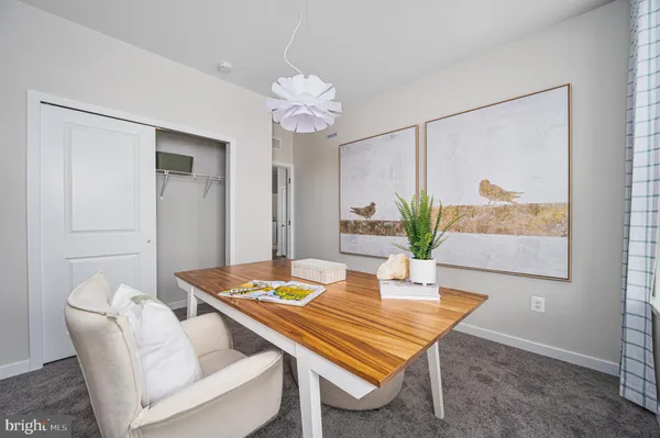 a dining room with furniture and wooden floor