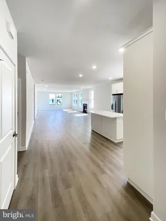 a view of a room with wooden floor and windows