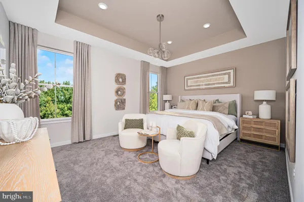a spacious bedroom with a bed and a chandelier