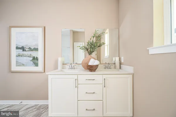 a bathroom with a sink a vanity and a large mirror
