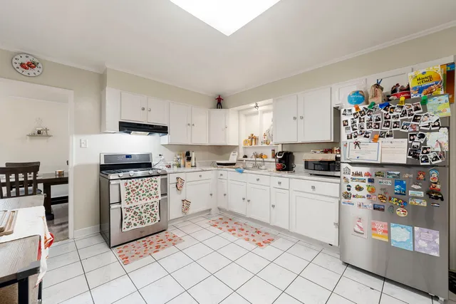 a kitchen with stainless steel appliances granite countertop a refrigerator sink and cabinets