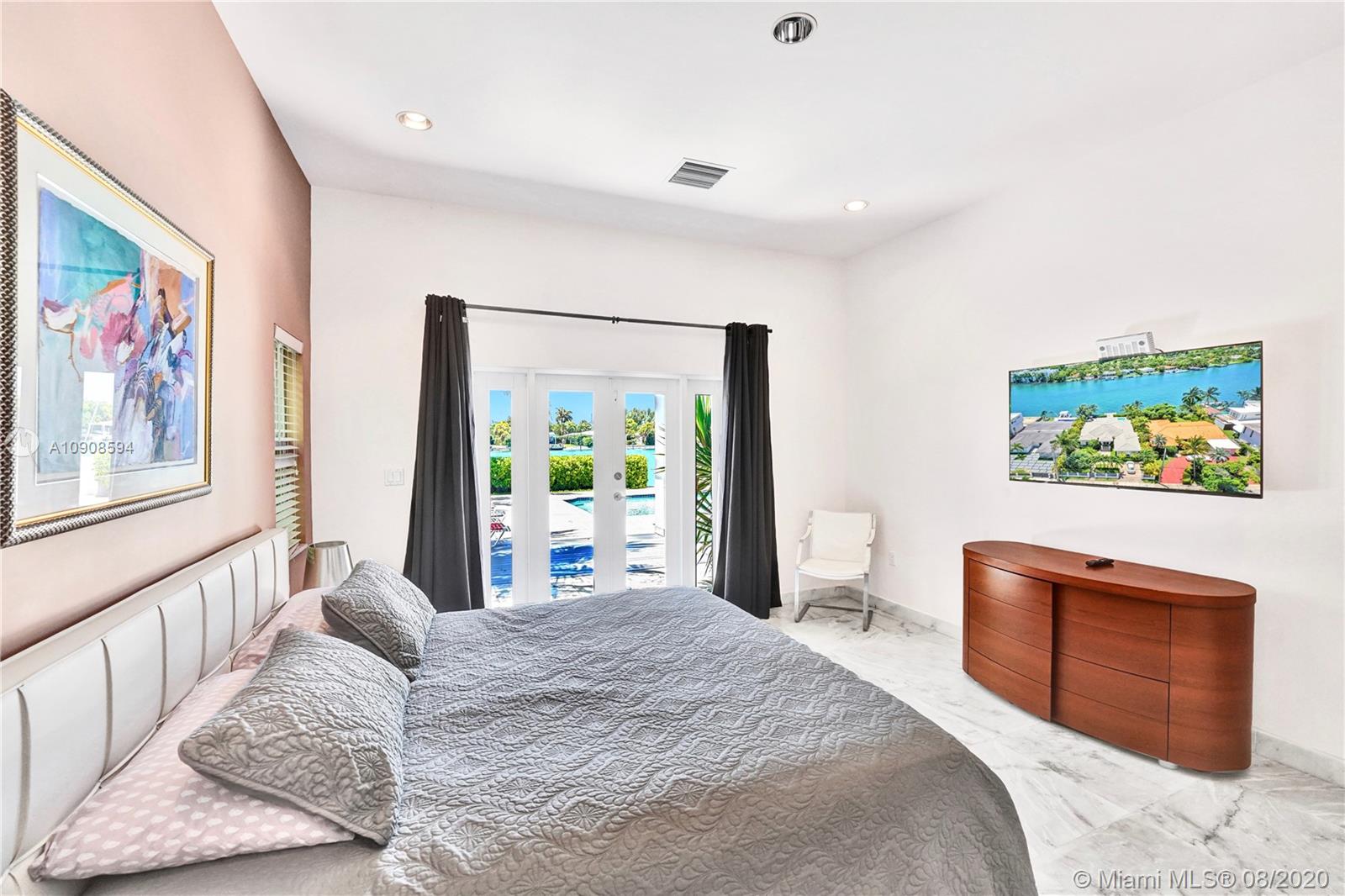 1158 South Biscayne Point Road Miami Beach, FL 33141 - Photo 14 of 38 a bedroom with a bed and a couch