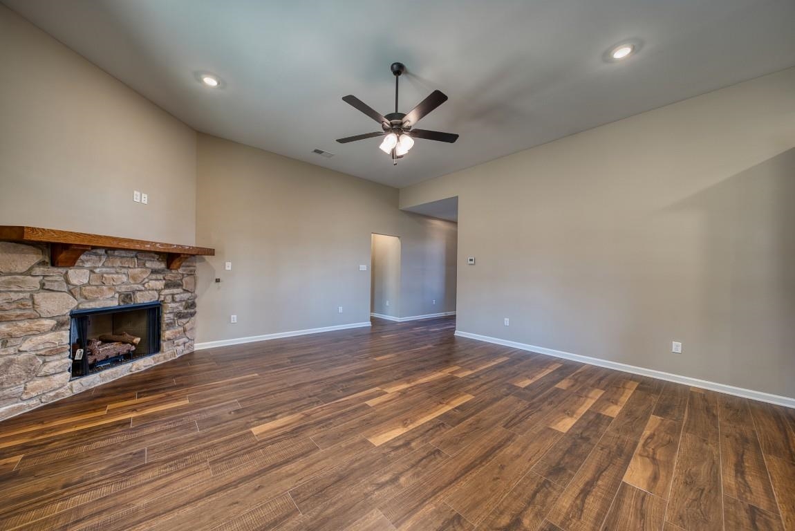 159 Como Lane Atoka, TN 38004 - Photo 9 of 38 a view of an empty room with wooden floor fireplace and a window