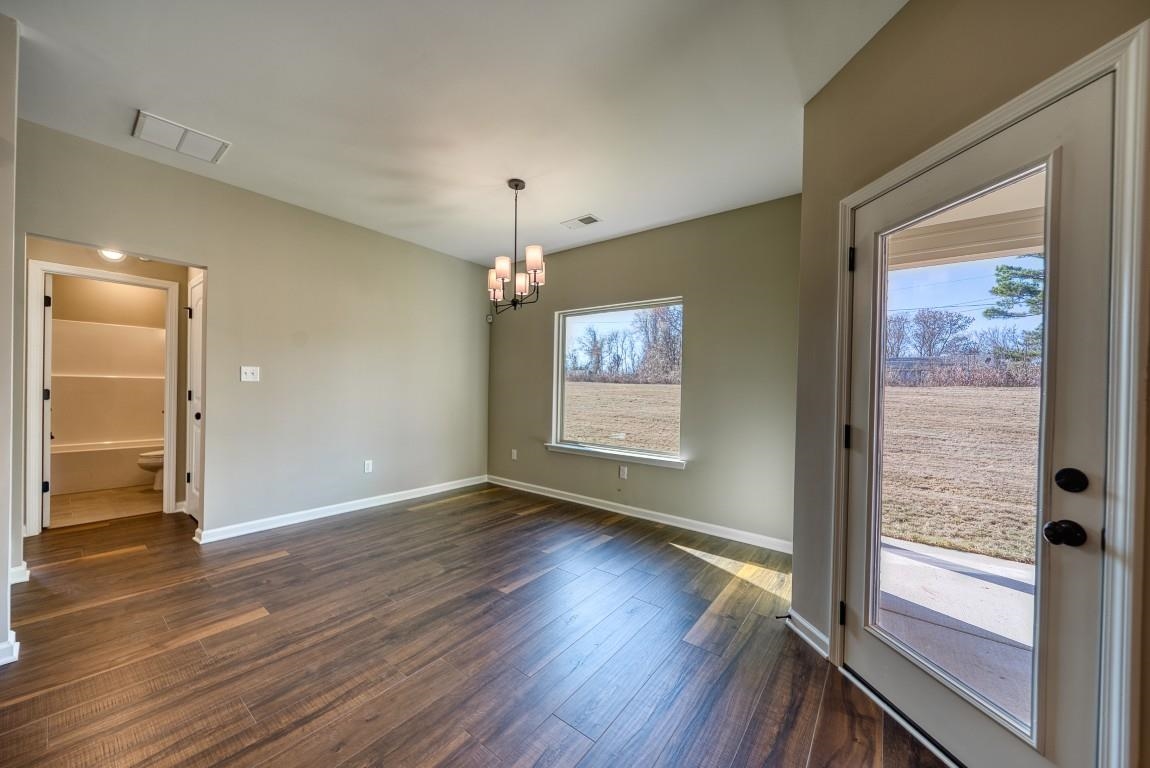 159 Como Lane Atoka, TN 38004 - Photo 10 of 38 wooden floor in an empty room with a window