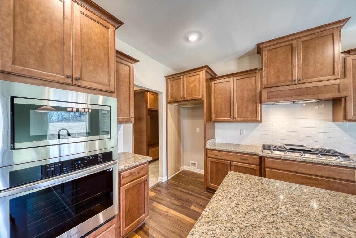 159 Como Lane Atoka, TN 38004 - Photo 2 of 38 a kitchen with stainless steel appliances granite countertop a stove and a refrigerator