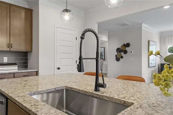 a kitchen with a granite countertop sink and a granite counter tops