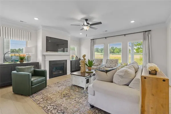a living room with furniture a fireplace and a flat screen tv